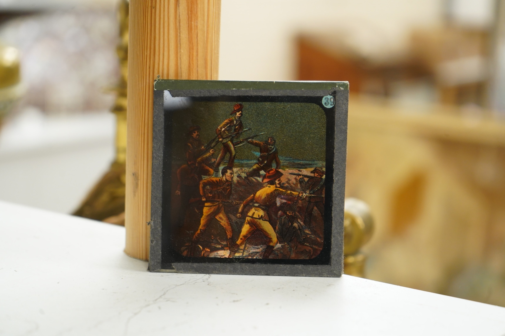 A group of sixteen Zulu War related magic lantern slides, plus some related contemporary newspaper cuttings pasted onto board referring to Rorke’s Drift